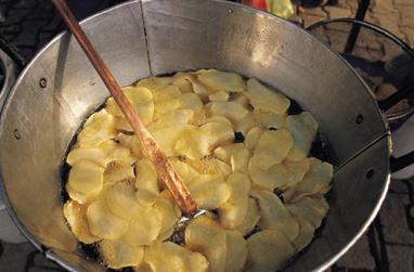 color photo of potato chips being fried in a wok